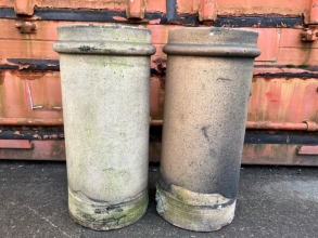 A pair of buff cylindrical pots