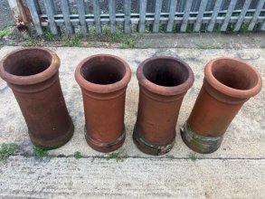 A set of four terracotta chimney pots