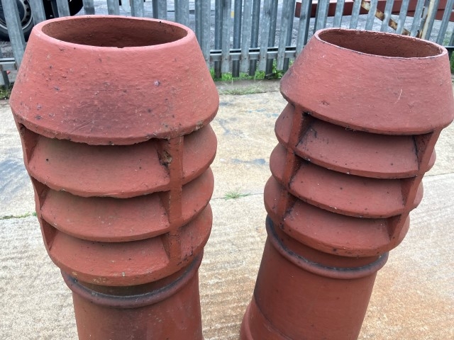 A pair of terracotta louvered chimney pots
