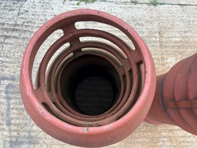 A pair of terracotta louvered chimney pots