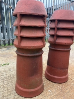 A pair of terracotta louvered chimney pots